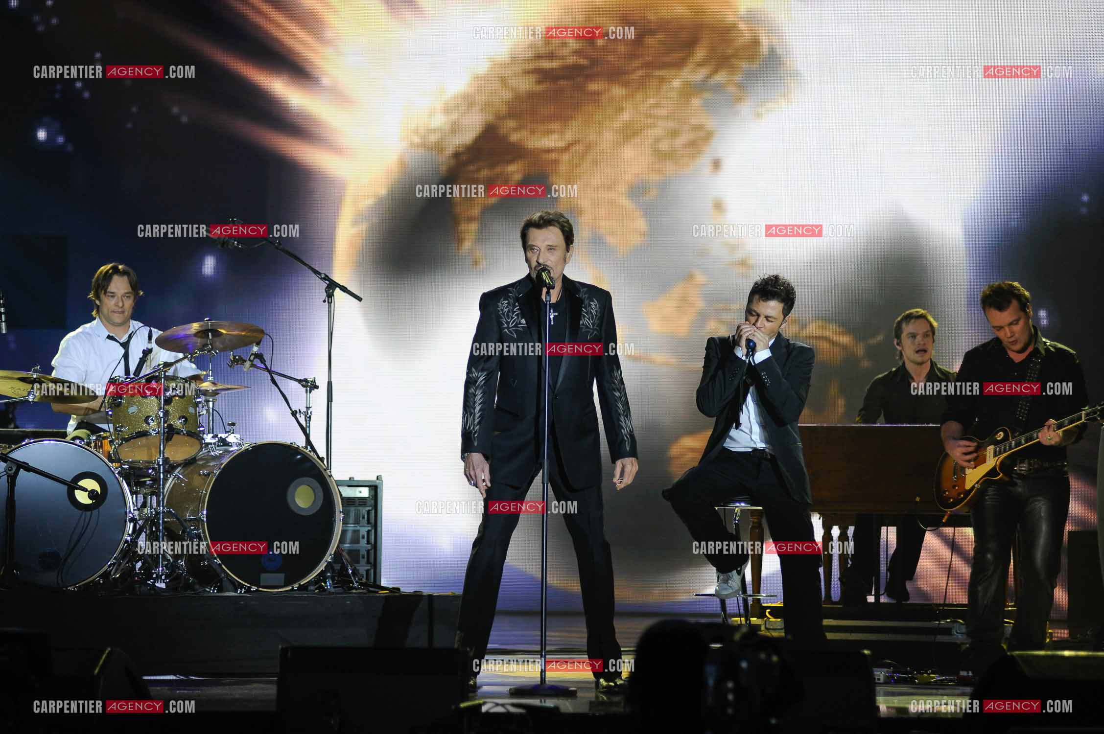Johnny Hallyday interprète “Ça peut changer le monde“ accompagné de son fils David Hallyday à la batterie, Christophe Maé à l'armonica, et Axel Bauer à la guitare aux Victoires de la musique en 2009 au Zénith de Paris.